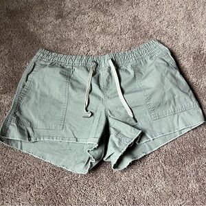 Vuori Women's Sage Green Cutoff Shorts.